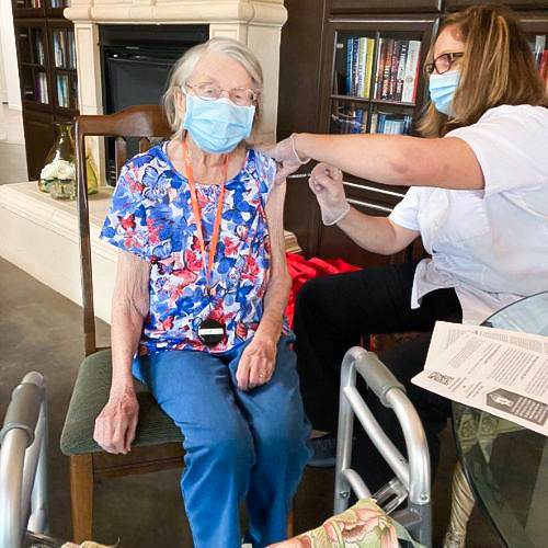 elderly woman getting vaccination