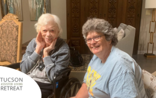 An older adult and her relative enjoy time in our assisted living facility where she receives senior care.